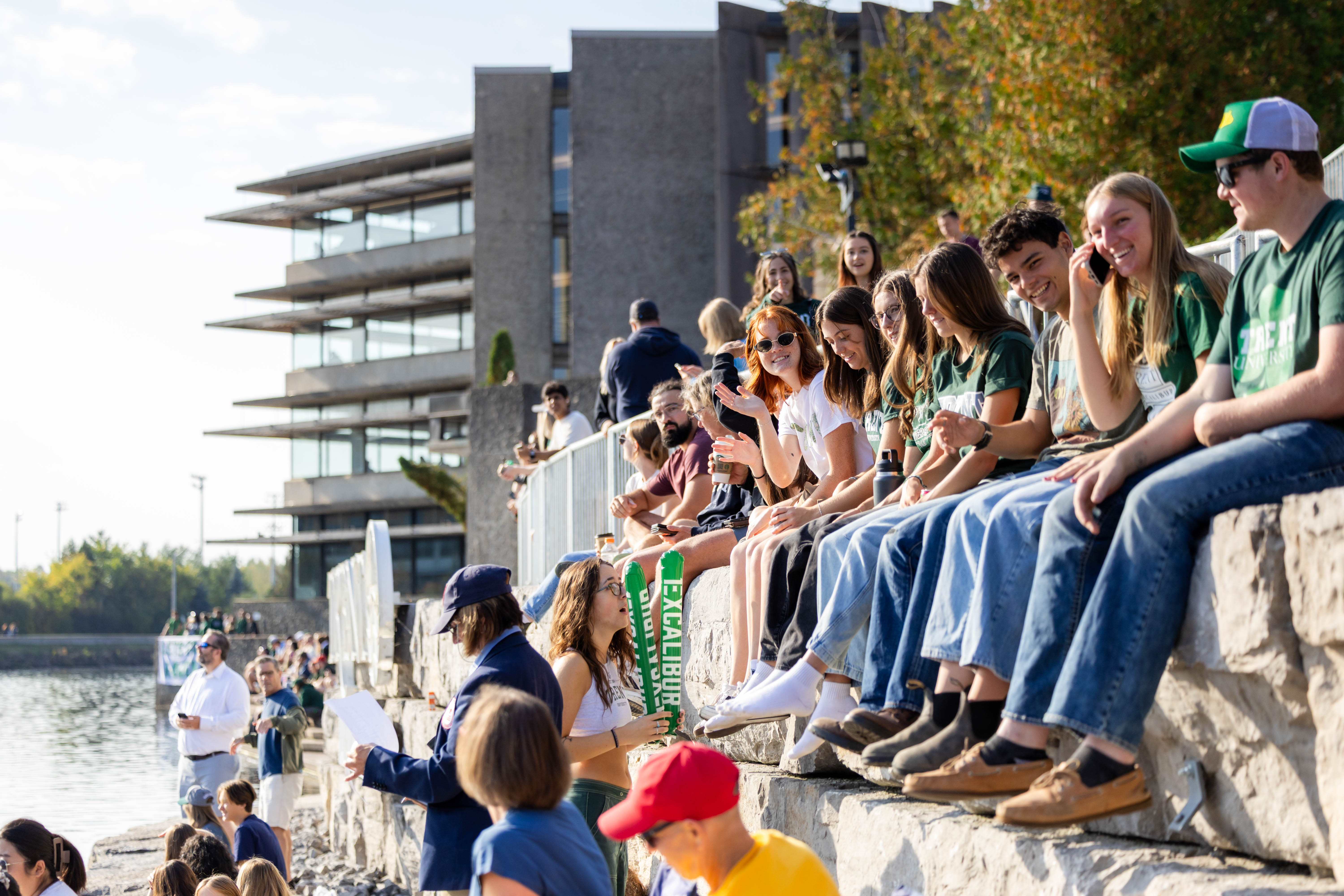 People sitting on the edge of a river