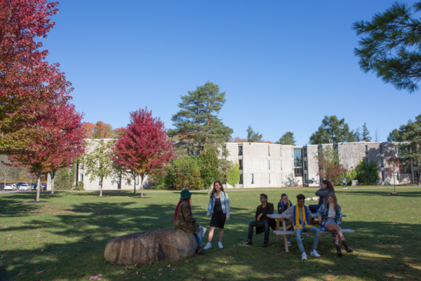 Lady Eaton College in the fall with some people mingling outside