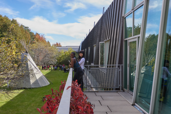 Otonabee College in the fall with some people mingling outside