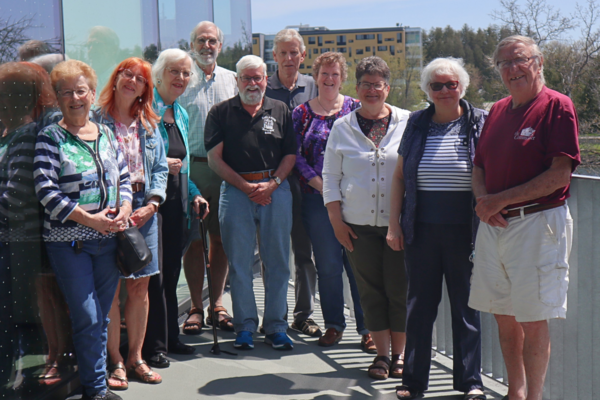 Group of retirees outside smiling at the camera