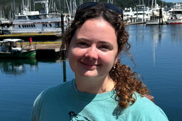Kelsey Scott with water and boats in the background