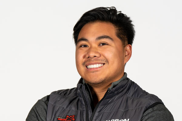 Man smiling at the camera with crossed arms