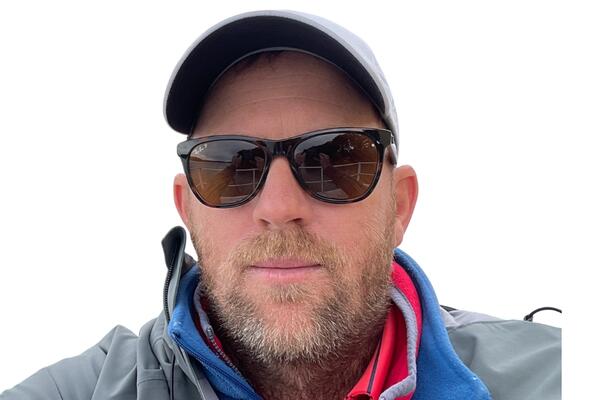 Peter Van Rooijen wearing a baseball hat and sunglasses
