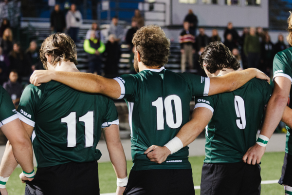 5 rugby players standing shoulder to shoulder