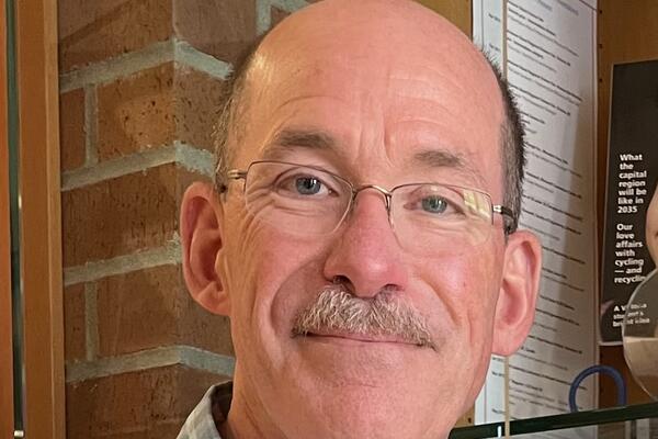 Man with glasses smiling at camera