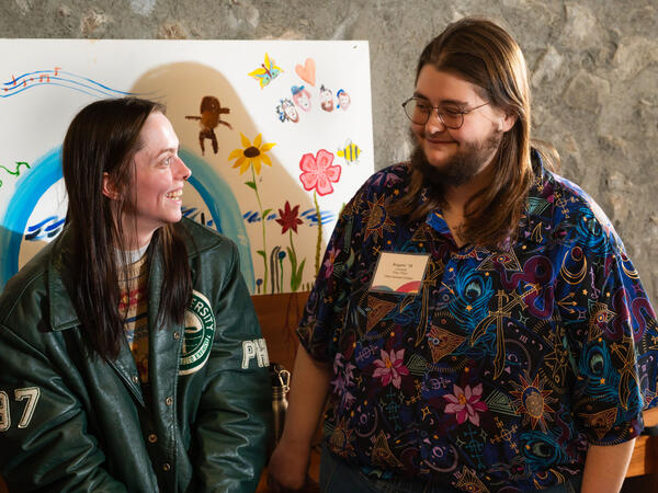 Two people smiling at each other.