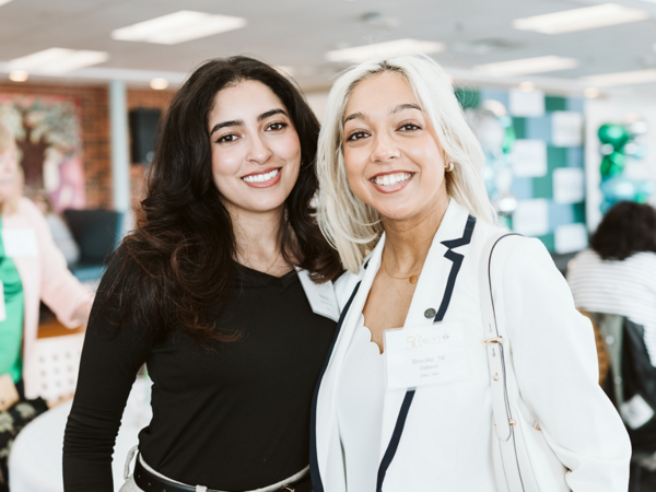 Two people smiling at the camera