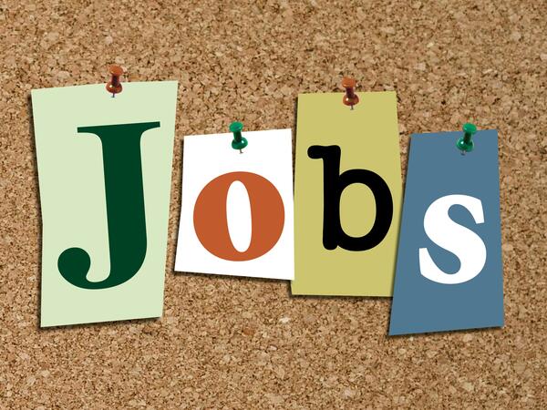 The word "Jobs" pinned to a corkboard, each letter on separate piece of paper