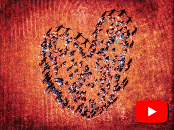 Areal image of people standing in heart formation