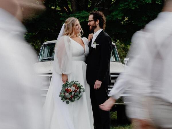 A couple at their wedding looking at each other lovingly