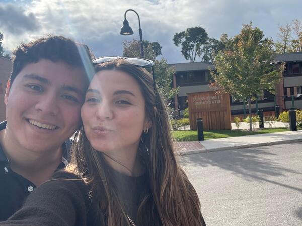 A couple taking a selfie outside of Traill College