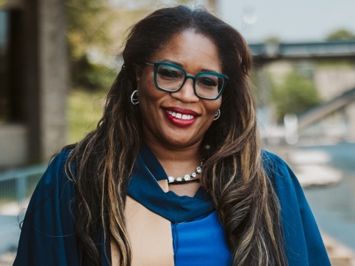 Claudette McGowan smiling in a Convocation gown