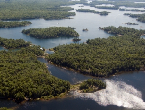 An aerial view of islands in a blue lake. 