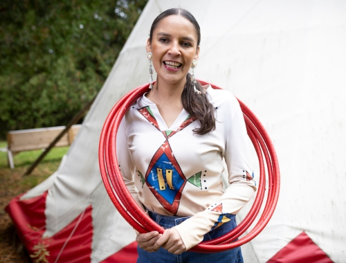 Sandra Lamouche smiling with hoops around her neck and shoulders