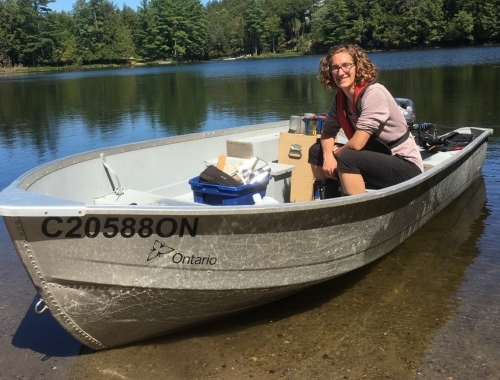 Brittany Welsh sits in a boat on a lake