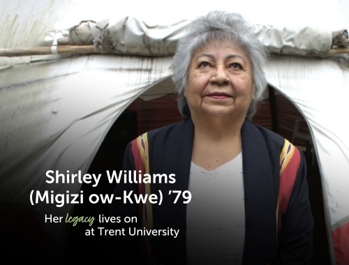 A woman standing outside of a tipi looking upwards
