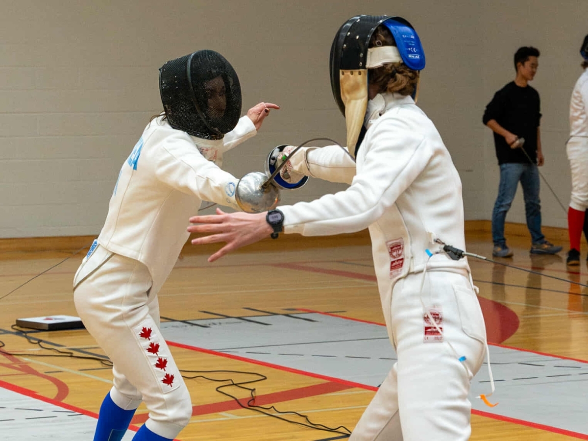 Two fencing players competing