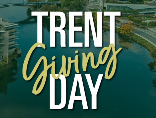 An aerial shot of the Otonabee River with Trent Giving Day text overtop