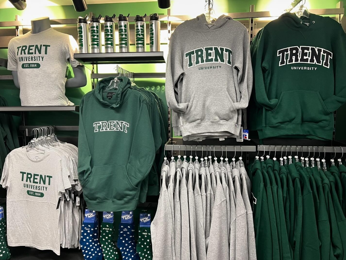 Inside of a store with Trent University hoodies hanging on the wall