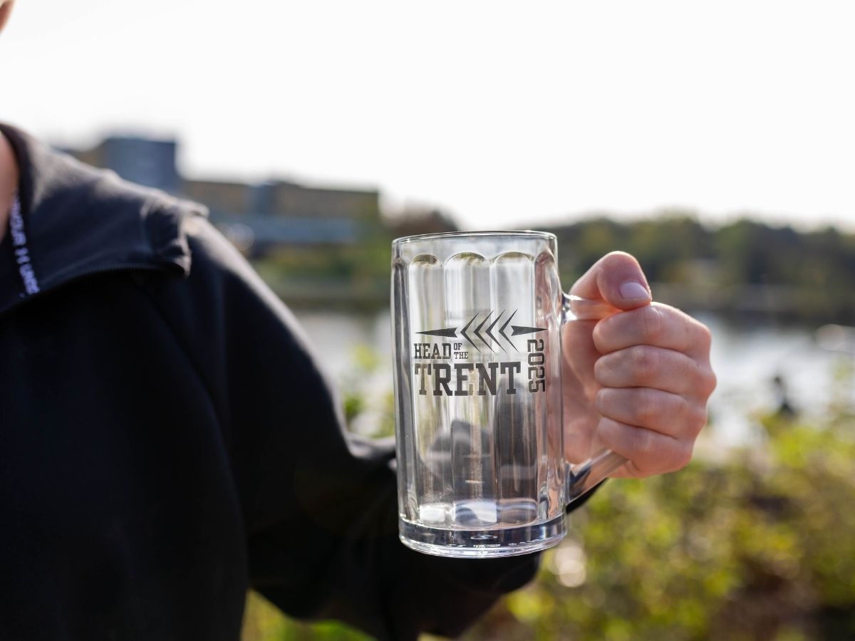 Someone holding up an empty beer stein