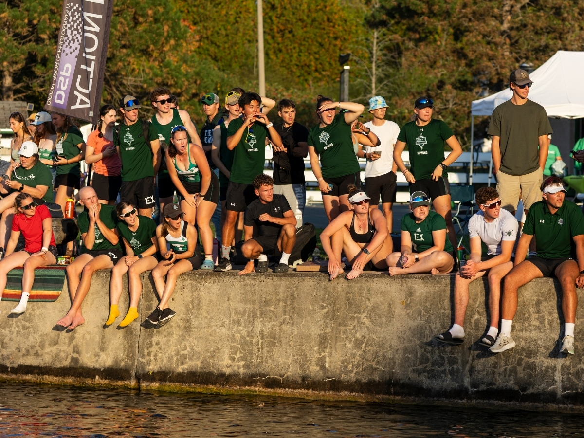 A group of people sitting on the banks of the river