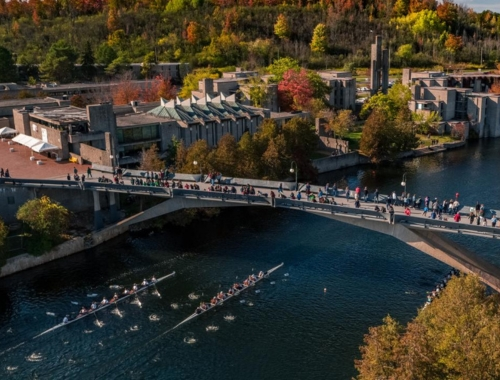 An aerial shot of the Otonabee River with a bridge and rowers
