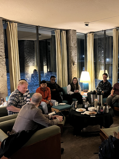 Group of students and alumni mentors sitting talking