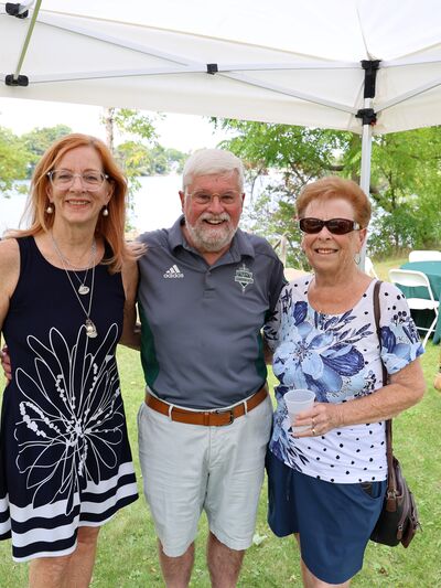 Three retirees standing outside