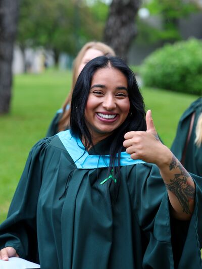 Graduate giving a thumbs-up