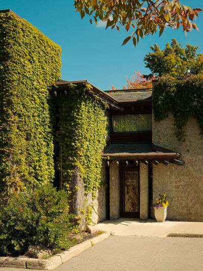 Alumni House front door, a Ron Thom building covered in green ivy