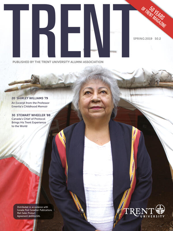 Shirley Williams standing in front of a tipi