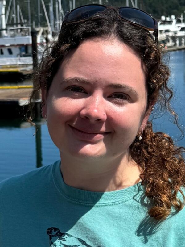 Kelsey Scott with water and boats in the background