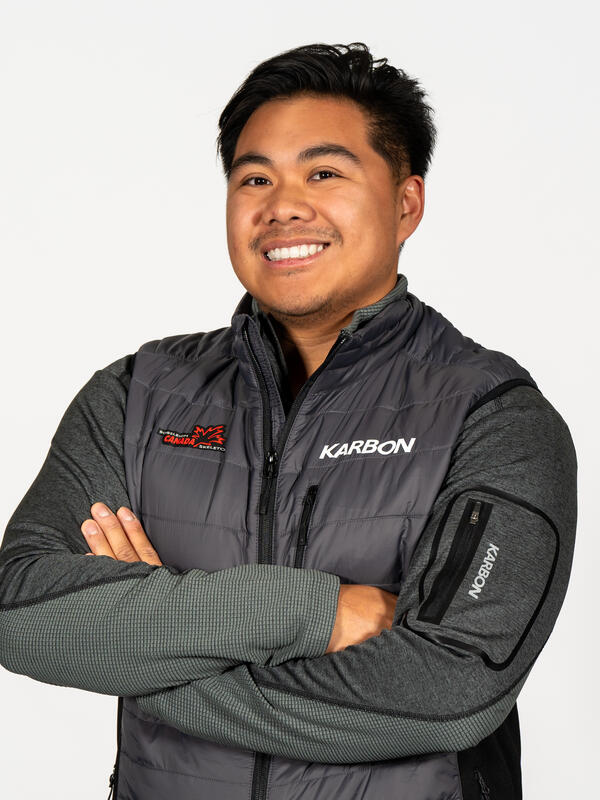 Man smiling at the camera with crossed arms