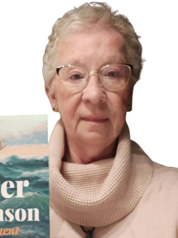 Mary English-Cooper holding up her book The Peter Robinson Experiment