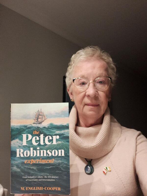 Woman holding her published book title the Peter Robinson Experiment