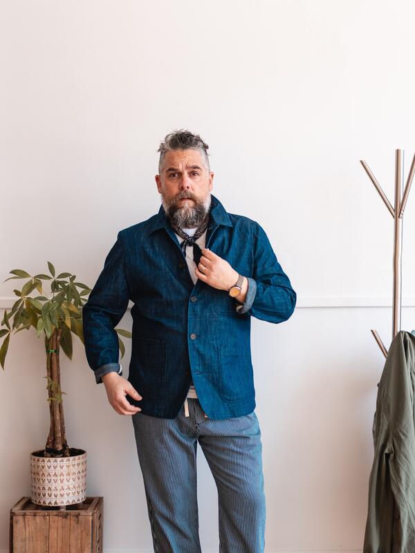 Man standing against a wall looking at the camera