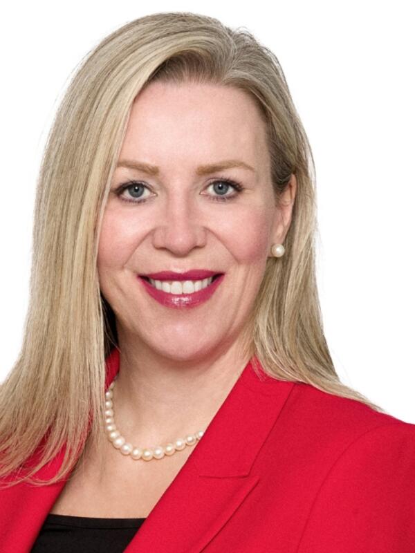 Shana French smiling in a red blazer