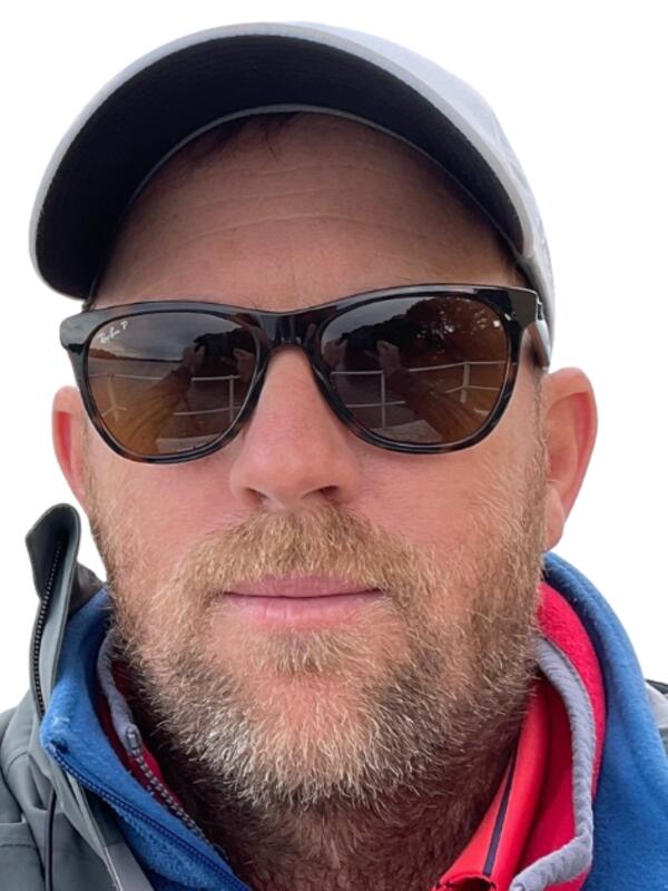 Peter Van Rooijen wearing a baseball hat and sunglasses